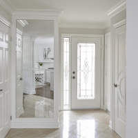 Light-flooring-with-white-walls-and-door.-bright-open-interior-with-mirror-and-decorative-white-doors-min