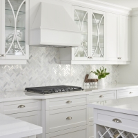 White-interior-kitchen-with-white-quatrz-countertop-and-custom-cabinetry-with-wine-rack-and-hardwood-flooring-min