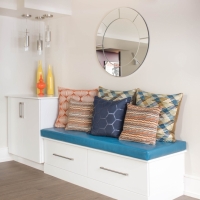 1_Basement-seating-with-white-custom-cabinetry-and-blue-and-orange-pillows