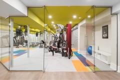Basement-gym-with-equiptment-and-benjamin-moore-chatreuse-ceiling-and-eden-carpet-tile-flooring