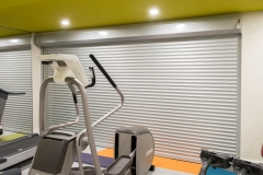 Basement-gym-with-metal-door-covering-electrical-and-gym-equiptment