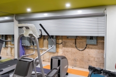 Basement-gym-with-metal-door-open-showing-electrical