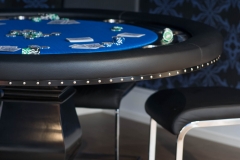 Basement-poker-table-with-blue-tabletop-and-wall-paper