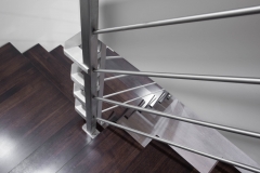 Basement-staircase-with-stainless-steel-wrap-around-railing-and-wooden-steps